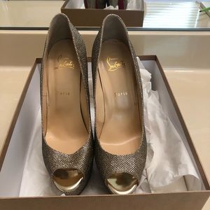 Gold Christian Louboutin 6” shoes.